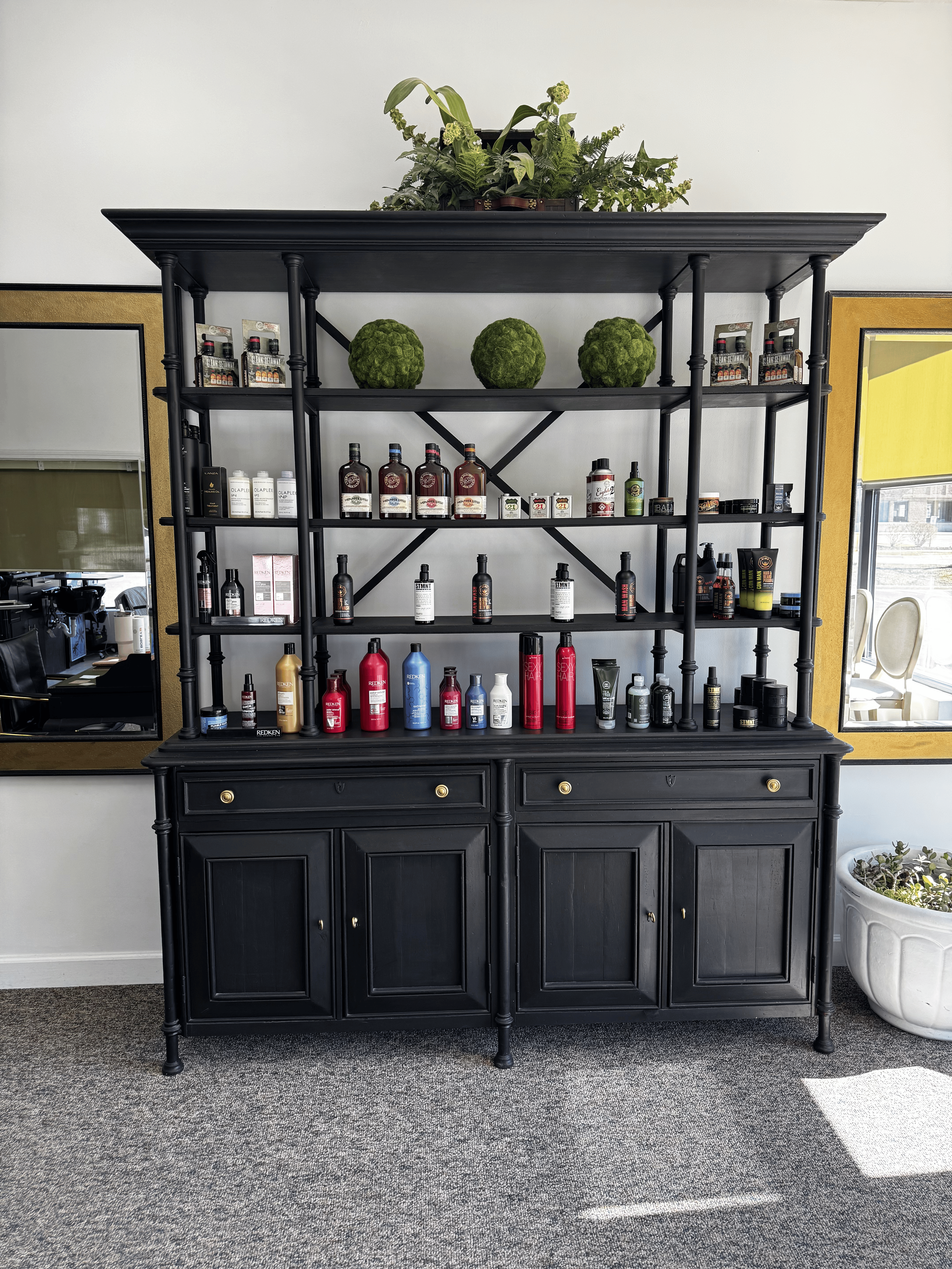 Beautiful black display shelf inside 88 Mane Street with grooming and salon products